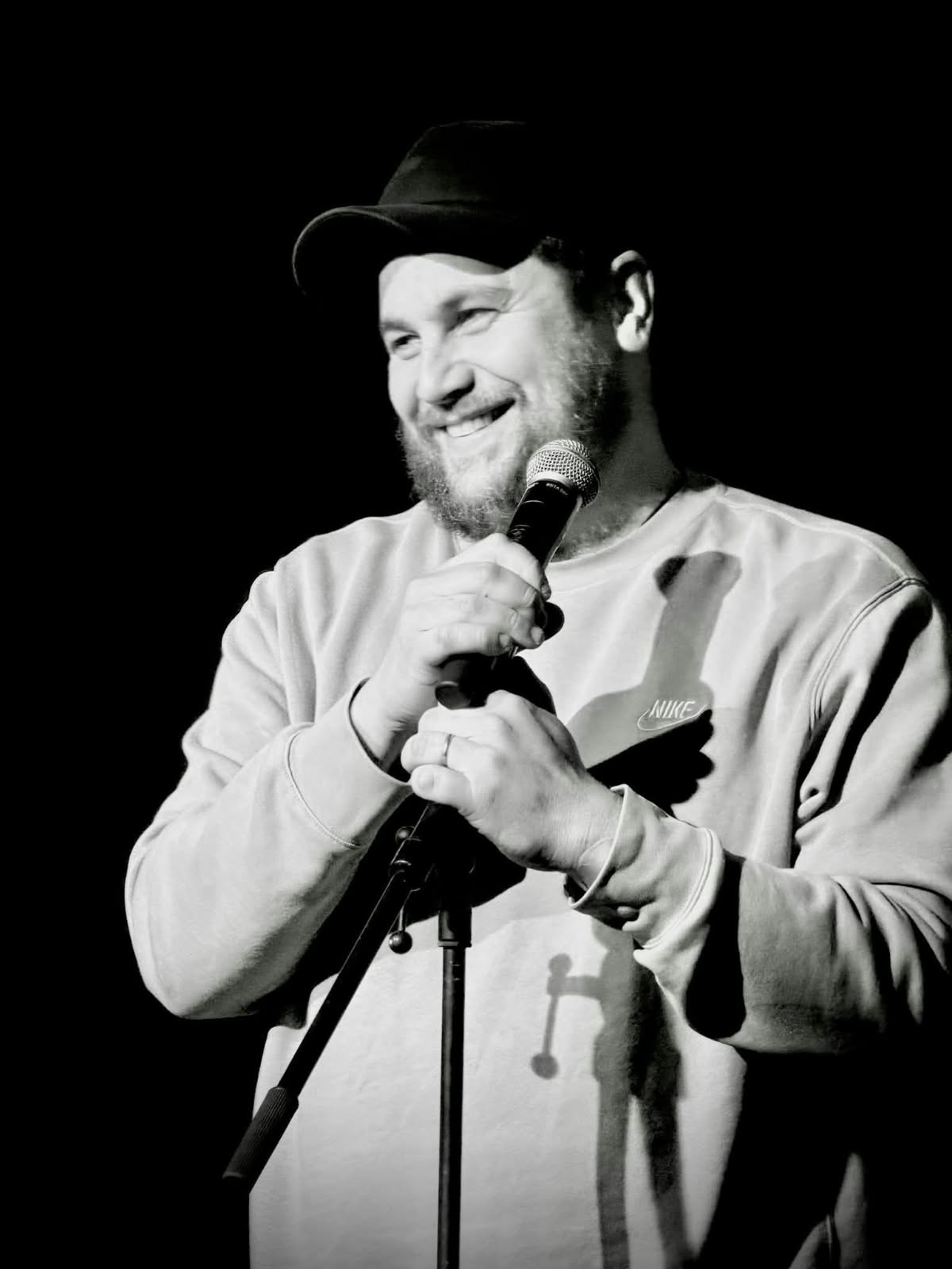 Nathan Drappa souriant sur scène, son micro à la main